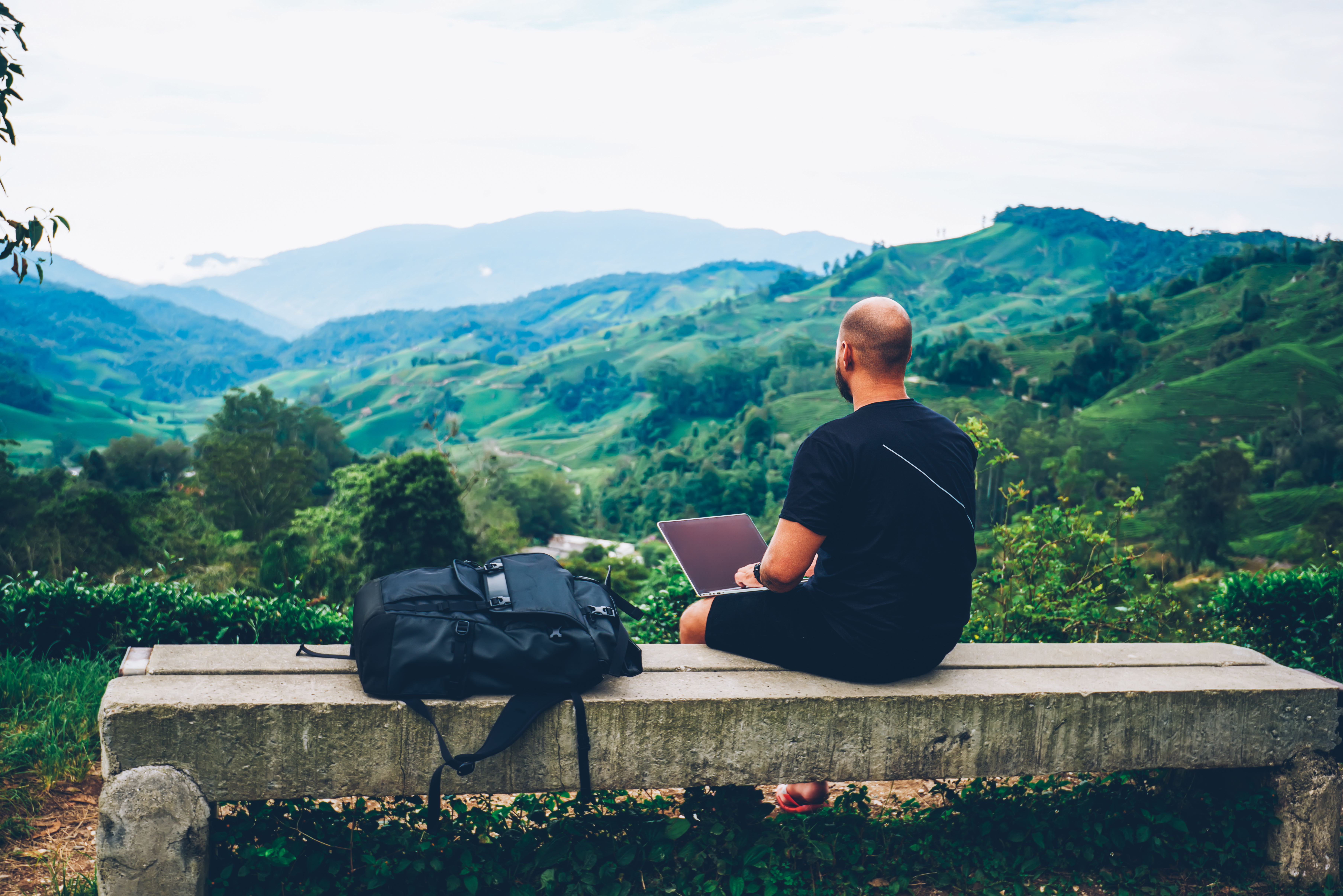 Man at computer using cloud technology to access apps in a remote location